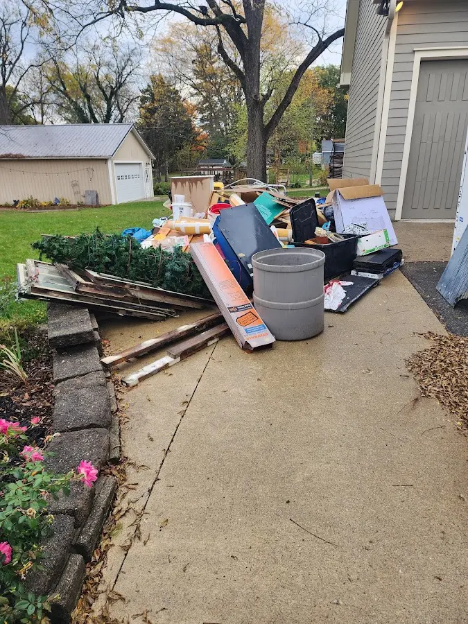 Dumpster being loaded with debris for 12 Yard Dumpster Rental in Newbury